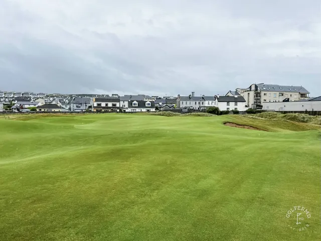 A wide view at Lahinch, with the dunes, the village, and the bay.