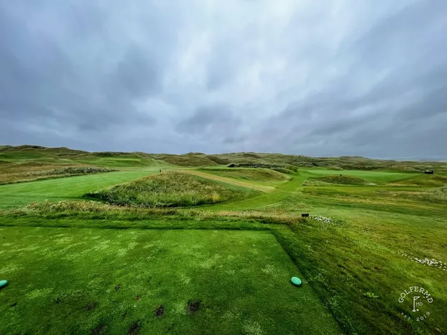Golfers on a tee at Lahinch, with the Atlantic behind them.