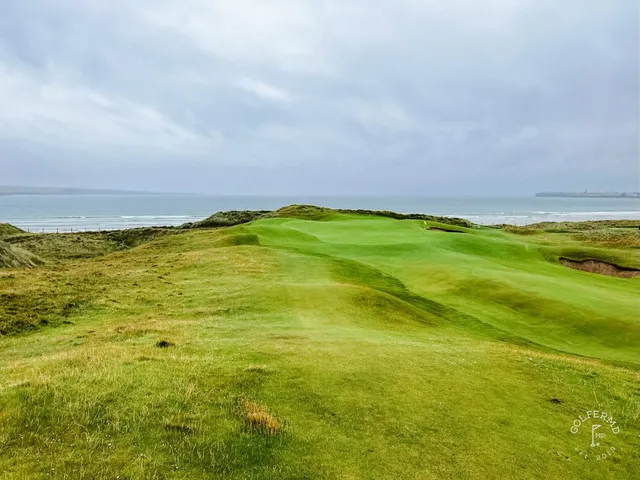 Another view of that green at Lahinch, with the bunker and the bay beyond.