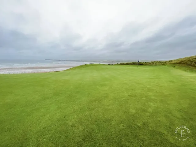 A wide view across Lahinch, with fairway, dunes, and the ocean.