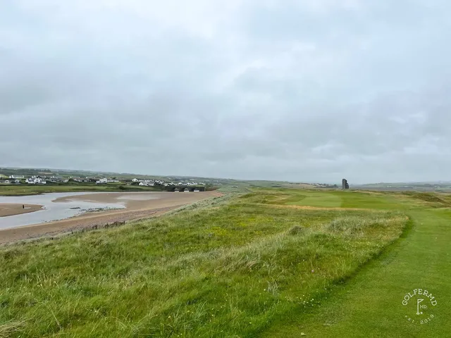 The clubhouse and the first hole at Lahinch, with the dunes beyond.