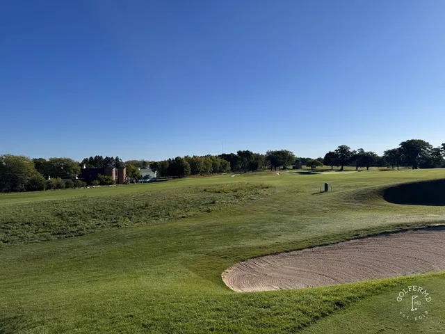 A green and flagstick at Lawsonia Links, with a bunker in front and open ground beyond.