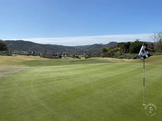 A fairway and green in the canyon at Maderas Golf Club, with hills around the hole.
