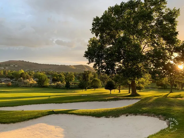 A wide fairway at Meadow Springs, with the hills in the distance.