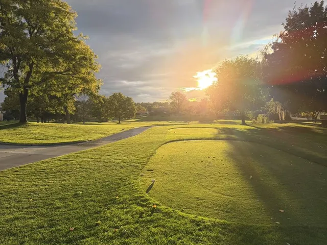 A wide view across Meadow Springs, with the fairway and the sky.