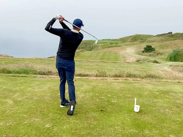A wide view of the Old Head of Kinsale, with the course on the cliffs above the water.