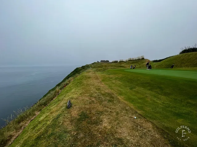 A fairway at Old Head with a bunker along one side and the ocean ahead.