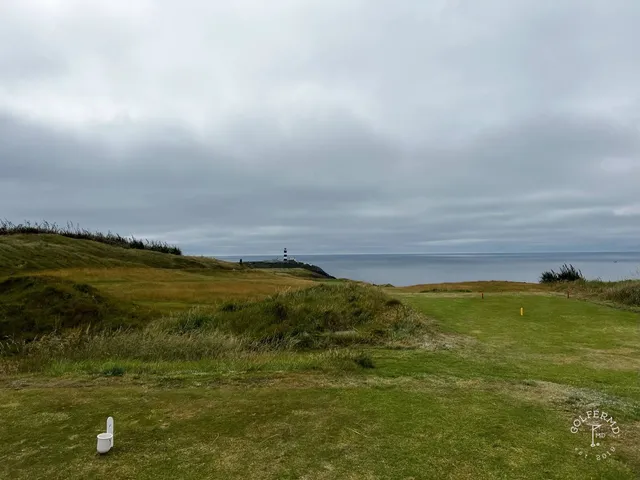A close view of a flagstick at Old Head, framed by the cliffs.