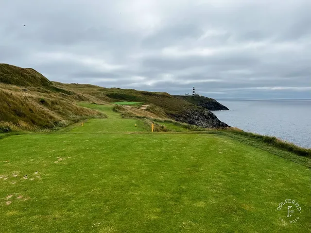 A fairway at Old Head with a bunker in the foreground and the water beyond.