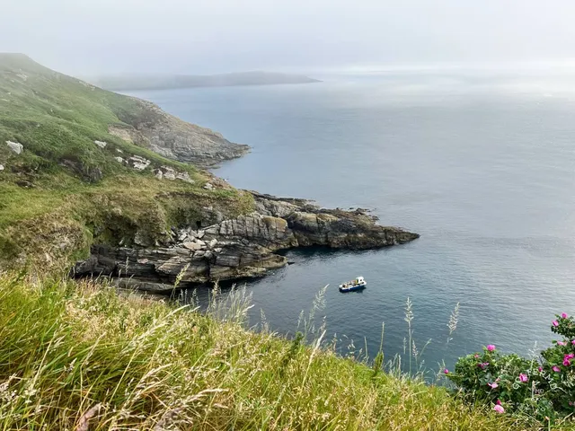 A close view of a flagstick at Old Head, with the Atlantic filling the background.