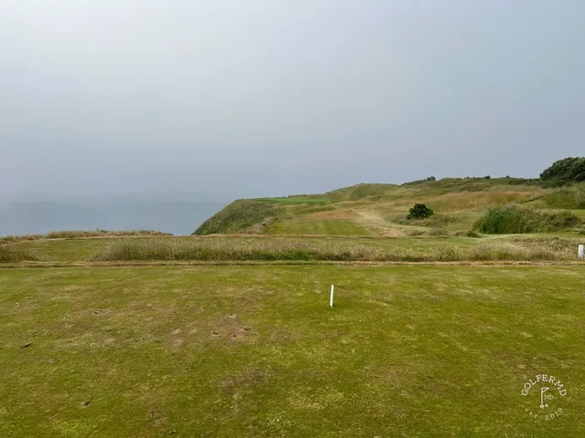 A wide fairway at Old Head dropping toward the cliff.