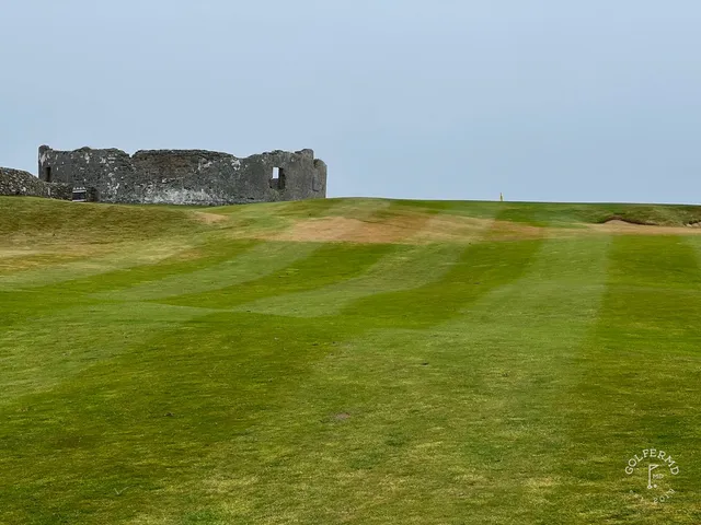 Golfers on a tee at Old Head, with the ocean and the sky behind them.