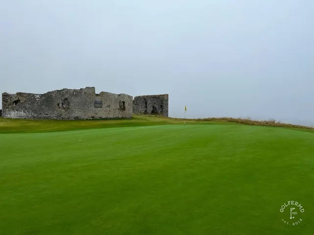 A fairway at Old Head, with a bunker along the hole and the water beyond.