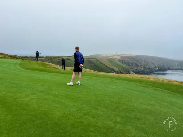 The Old Head lighthouse from the cliffs beside the course.