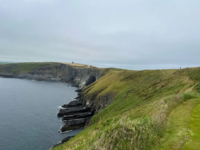 A fairway at Old Head running toward the point, with the water on both sides.