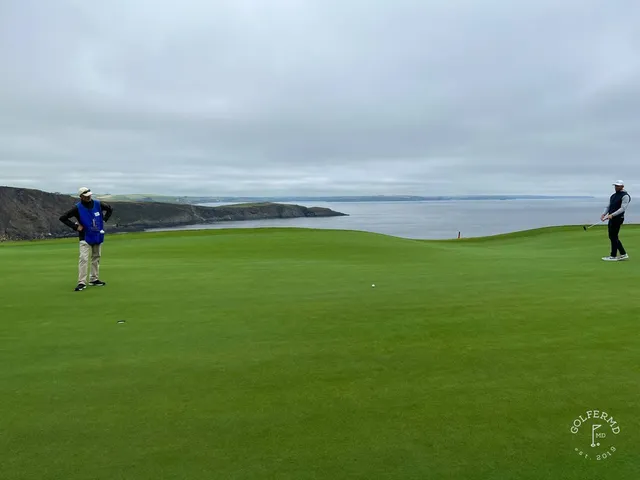 A fairway at Old Head with gorse and the ocean in the background.