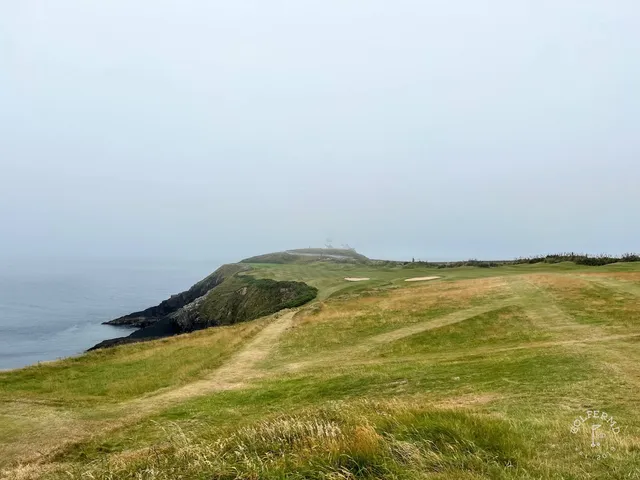 A wide view down the headland at Old Head, with hole after hole above the water.
