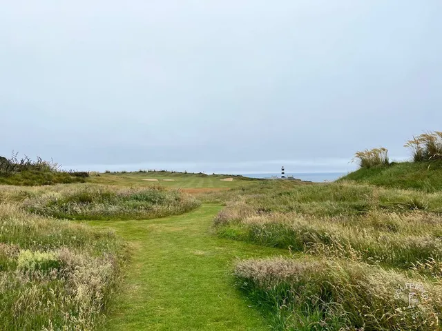 A wide view across the bay from Old Head, with the course in the foreground.