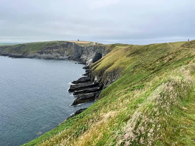 A last close view of a flagstick at Old Head, with the water far below.