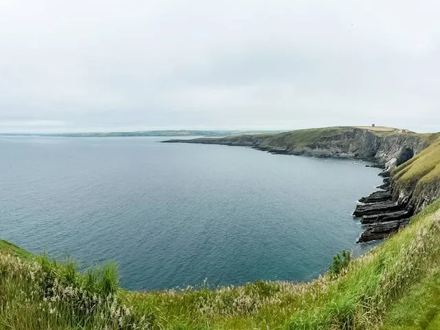 A fairway at Old Head with the lighthouse at the end of the headland.