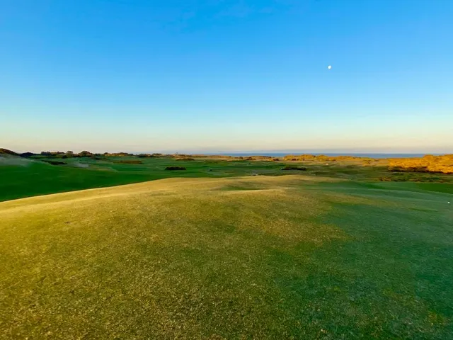 The coastline from Old Macdonald, with the fairway and the Pacific under a cloudy sky.