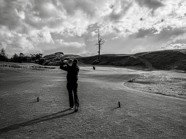 A wide fairway at Old Macdonald, dunes along the hole and the ocean on the horizon.