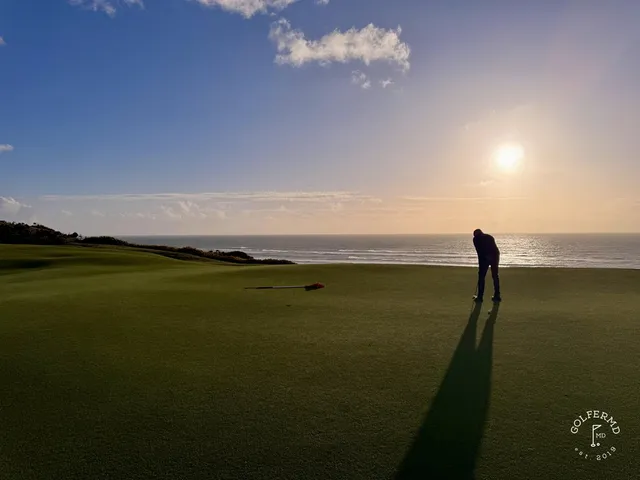 A tee shot at Old Macdonald, the fairway dropping toward a green set above the ocean.