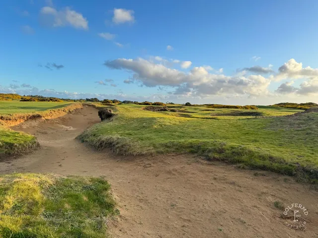 A wide links view at Old Macdonald, the course spread across the dunes toward the sea.