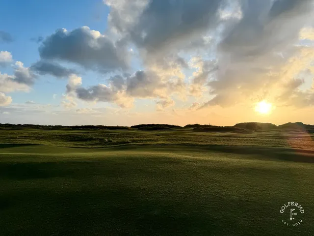 A tee view at Old Macdonald with bunkers on both sides and the ocean ahead of the green.