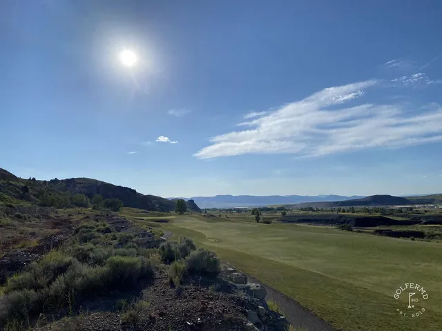 A green and flagstick at Old Works, with a large black bunker guarding the front.