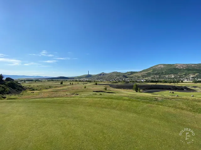 A fairway at Old Works, with a black bunker in the foreground and the mountains behind.