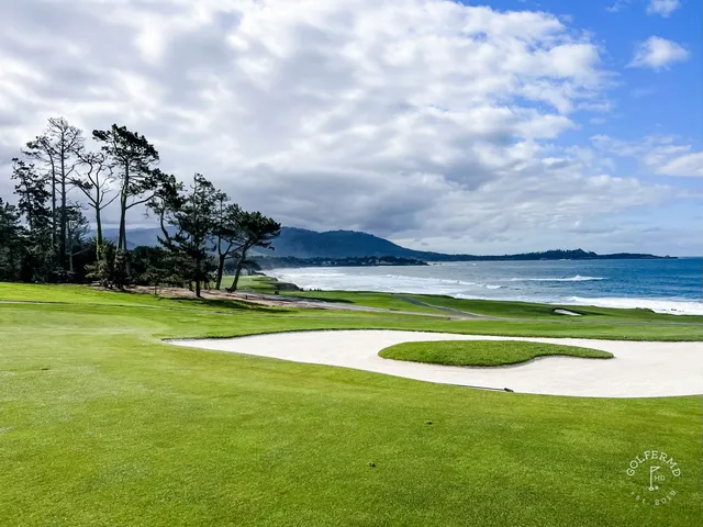 Three people on a green at Pebble Beach Golf Links, one of them putting, with the ocean behind them.