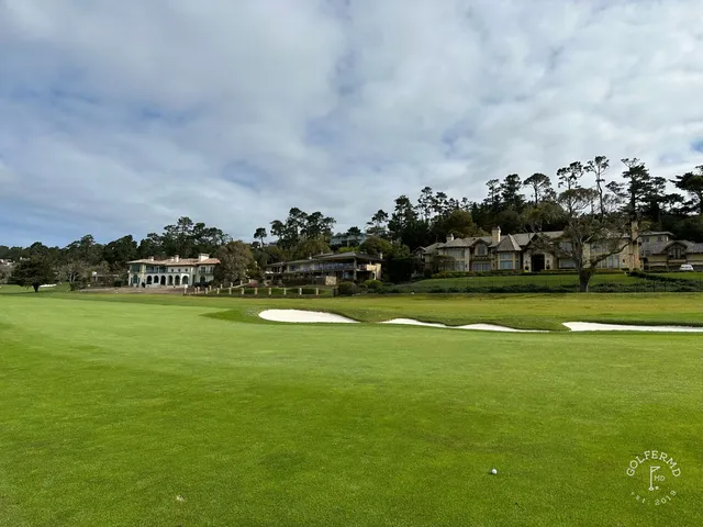 Two people on a path along the coast at Pebble Beach Golf Links.