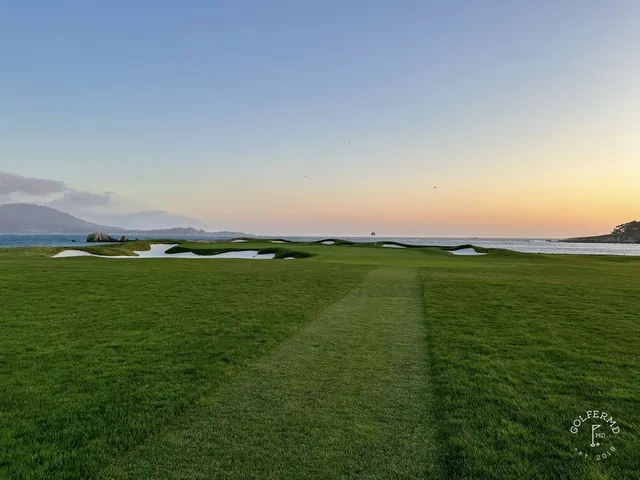 A golfer putting on a green at Pebble Beach Golf Links, with the ocean in the background.