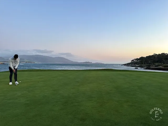 A golfer putting on a green beside the ocean at Pebble Beach Golf Links.