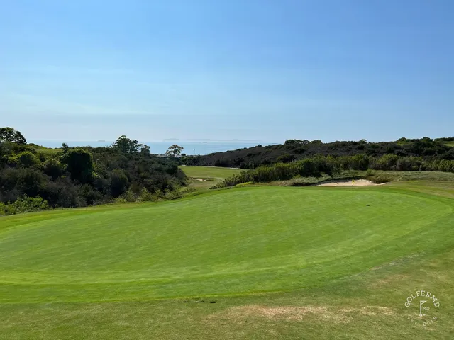 A fairway leading toward the ocean at Pelican Hill Ocean North Course, with a bunker on the right.