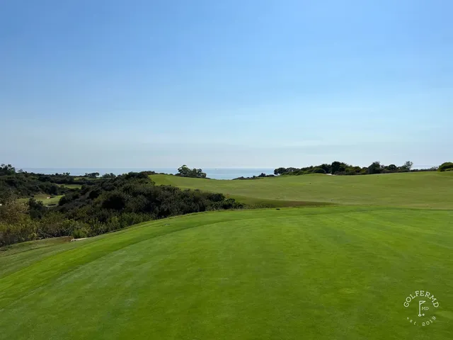 A fairway running toward the ocean at Pelican Hill Ocean North Course, with a bunker along the left.