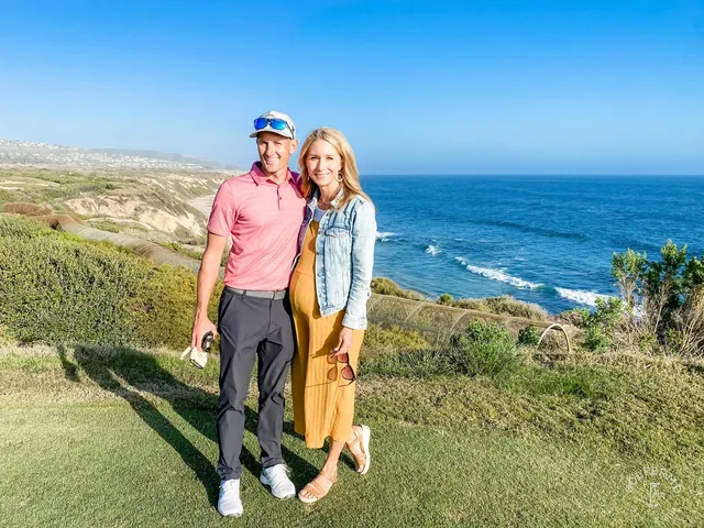 A golfer hitting a fairway shot at Pelican Hill Ocean South Course, with the ocean and a cypress tree behind the shot.
