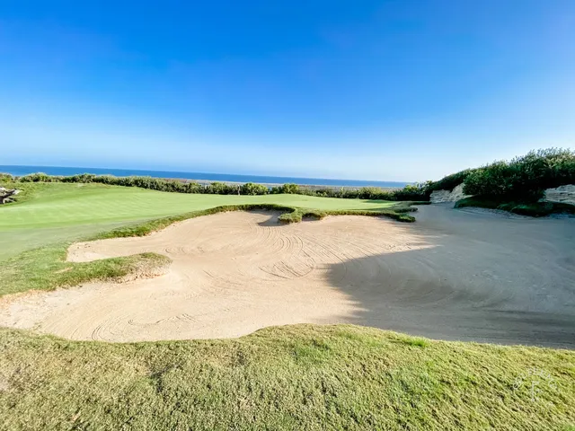 A fairway running toward the ocean at Pelican Hill Ocean South Course, with bunkers along the hole.