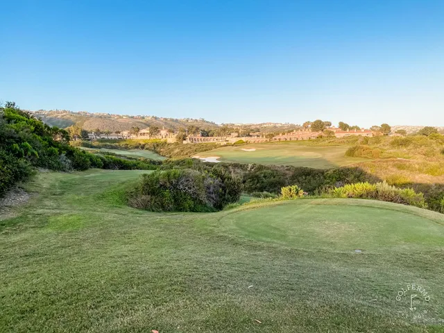 A fairway leading toward the ocean at Pelican Hill Ocean South Course, with a bunker on the right.