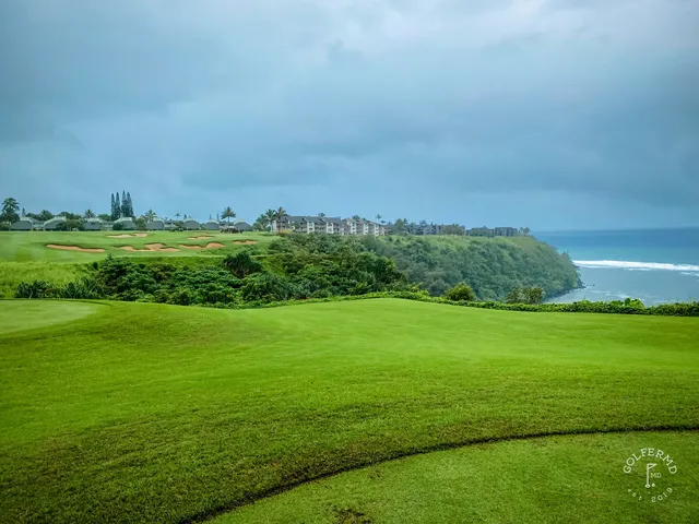A wide fairway at Princeville Makai, with the mountains of Kauai and the ocean in the distance.