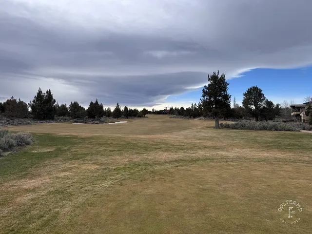 A wide view at Pronghorn, with sage, the fairway, and the mountains.