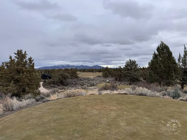 A fairway and green at Pronghorn, with a bunker in the foreground.