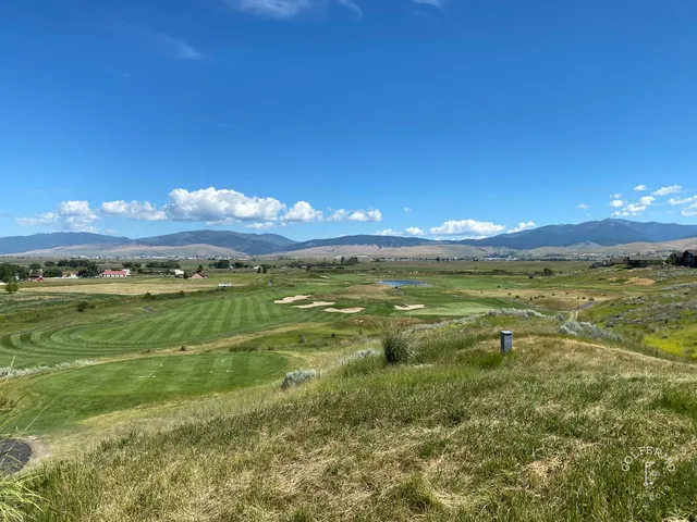 A wide view at The Ranch Club, with the fairway and the Mission Mountains in the distance.