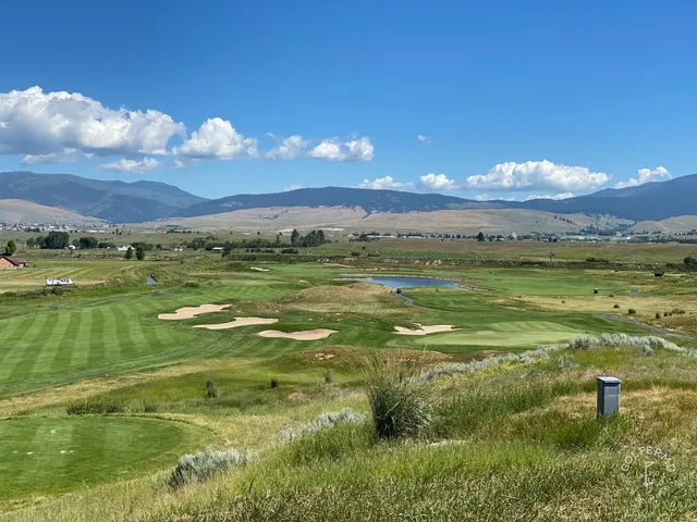 A golfer hitting a shot at The Ranch Club, with the fairway and mountains ahead.