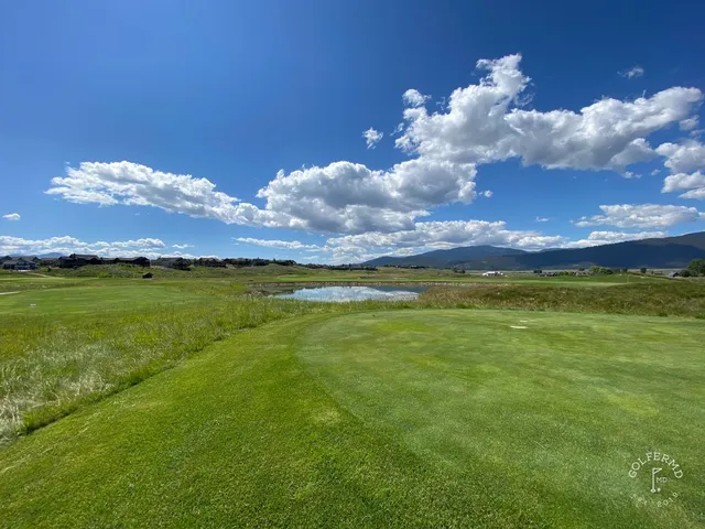 Golfers on a tee at The Ranch Club, with the mountains behind them.