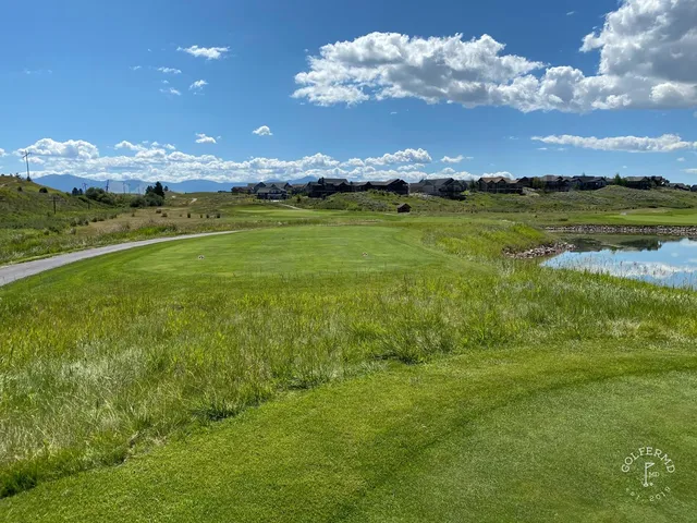 A wide fairway at The Ranch Club, with trees along the hole and mountains on the horizon.