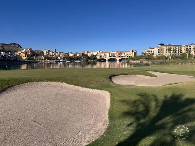 Golfers on a tee at Reflection Bay, with Lake Mead and the mountains behind them.