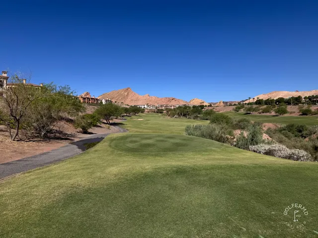 A wide fairway at Reflection Bay, with the lake and desert mountains in the distance.