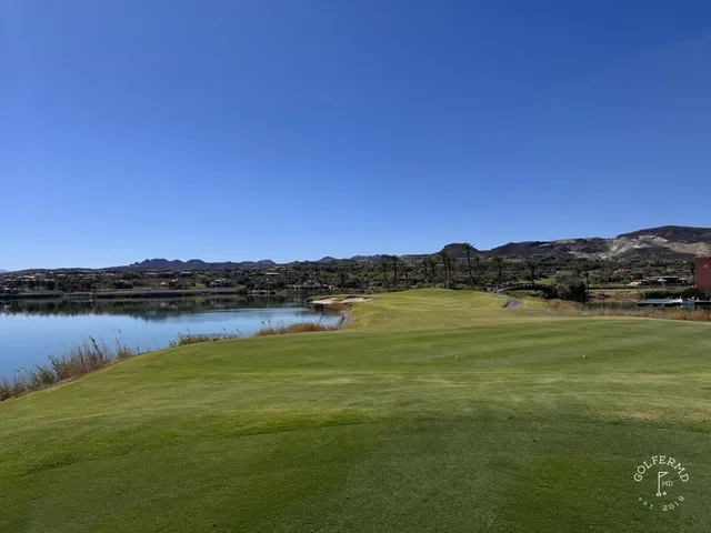 A fairway at Reflection Bay with a bunker along the right and the water in the distance.